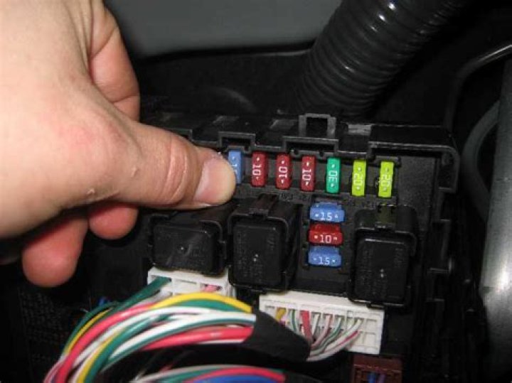 Where is the car alarm fuse located?